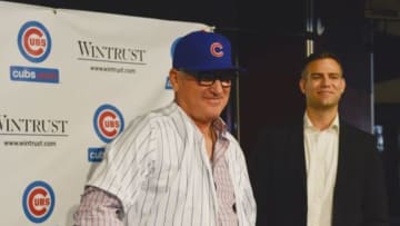 Nov 3, 2014; Chicago, IL, USA; Chicago Cubs manager Joe Maddon (left) wears his hat and jersey in front of president of baseball operations Theo Epstein (right) as Maddon is introduced during a press conference at the Cubby Bear Lounge near Wrigley Field. Mandatory Credit: Matt Marton-USA TODAY Sports