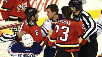 Dec 27, 2014; Calgary, Alberta, CAN; Calgary Flames defenseman Dennis Wideman (6) and center Sean Monahan (23) fight with Edmonton Oilers left wing Matt Hendricks (23) and defenseman Andrew Ference (21) during the third period at Scotiabank Saddledome. The Flames won 4-1. Mandatory Credit: Candice Ward-USA TODAY Sports