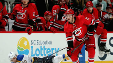 RALEIGH, NC - OCTOBER 27: Brett Pesce #22 of the Carolina Hurricanes collects the puck as Brayden Schenn #10 of the St. Louis Blues falls to the ice during an NHL game on October 27, 2017 at PNC Arena in Raleigh, North Carolina. (Photo by Gregg Forwerck/NHLI via Getty Images)