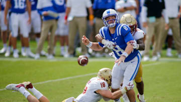 Duke football quarterback Chase Brice fumbles after a sack. (Photo by Nell Redmond-Pool/Getty Images)