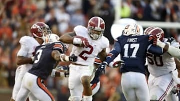 Nov 28, 2015; Auburn, AL, USA; Alabama Crimson Tide running back Derrick Henry (2) carries the ball past Auburn Tigers defensive back Jonathan Jones (3) and Kris Frost (17) in the second quarter at Jordan Hare Stadium. Mandatory Credit: RVR Photos-USA TODAY Sports