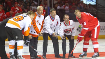 Sep 22, 2011; London, ON, Canada; Detroit Red Wings defenseman Nicklas Lidstrom (5), Philadelphia Flyers right wing Claude Giroux (28) and NHL Hall of Fame inductee Mark Howe (fourth from right) during the ceremonial face-off at John Labatt Centre. The Red Wings beat the Flyers 4-3. Mandatory Credit: Tom Szczerbowski-USA TODAY Sports