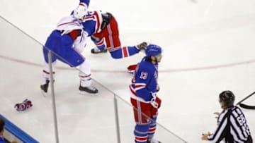 May 22, 2014; New York, NY, USA; Montreal Canadiens right wing Brandon Prust (8) fights with New York Rangers right wing Derek Dorsett (15) as left wing Daniel Carcillo (13) skates towards linesman Scott Driscoll (68) during the first period in game three of the Eastern Conference Final of the 2014 Stanley Cup Playoffs at Madison Square Garden. Mandatory Credit: Andy Marlin-USA TODAY Sports