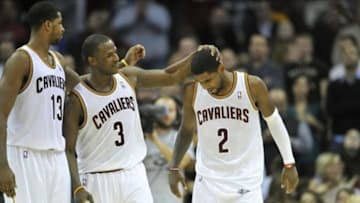 Nov 9, 2013; Cleveland, OH, USA; Cleveland Cavaliers point guard Kyrie Irving (2) is consoled by power forward Tristan Thompson (13) and shooting guard Dion Waiters (3) after missing a shot at the end of regulation against the Philadelphia 76ers at Quicken Loans Arena. Mandatory Credit: David Richard-USA TODAY Sports