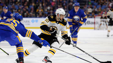 Mar 19, 2023; Buffalo, New York, USA; Boston Bruins left wing A.J. Greer (10) skates with the puck as Buffalo Sabres defenseman Owen Power (25) defends during the third period at KeyBank Center. Mandatory Credit: Timothy T. Ludwig-USA TODAY Sports
