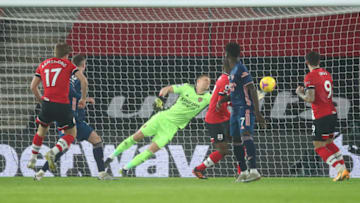 SOUTHAMPTON, ENGLAND - JANUARY 26: Stuart Armstrong of Southampton scores his team's first goal past Bernd Leno of Arsenal during the Premier League match between Southampton and Arsenal at St Mary's Stadium on January 26, 2021 in Southampton, England. Sporting stadiums around the UK remain under strict restrictions due to the Coronavirus Pandemic as Government social distancing laws prohibit fans inside venues resulting in games being played behind closed doors. (Photo by Marc Atkins/Getty Images)