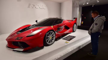 A visitor looks at a Ferrari FXX K at the Ferrari Museum on October 18, 2015 in Maranello. Fiat Chrysler Automobiles is planning a US stock debut for Ferrari that values the luxury Italian sports carmaker at nearly $10 billion, according to a filing with US regulators on October 10, 2015. Ferrari, of the famed 'prancing stallion' logo, will make its first steps on Wall Street, expected in late October, after years of rumors. AFP PHOTO / GIUSEPPE CACACE (Photo credit should read GIUSEPPE CACACE/AFP/Getty Images)