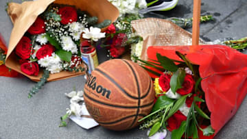 People gather around a makeshift memorial for former NBA and Los Angeles Lakers player Kobe Bryant after learning of his death at LA Live plaza in front of Staples Center in Los Angeles on January 26, 2020. - NBA legend Kobe Bryant died January 26, 2020 in a helicopter crash in suburban Los Angeles, celebrity website TMZ reported, saying five people are confirmed dead in the incident. (Photo by Frederic J. Brown / AFP) (Photo by FREDERIC J. BROWN/AFP via Getty Images)