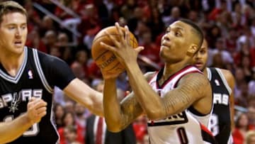 May 12, 2014; Portland, OR, USA; Portland Trail Blazers guard Damian Lillard (0) drives to the basket against the San Antonio Spurs during the fourth quarter in game four of the second round of the 2014 NBA Playoffs at the Moda Center. Mandatory Credit: Craig Mitchelldyer-USA TODAY Sports