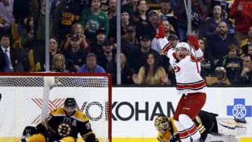 Mar 10, 2016; Boston, MA, USA; Carolina Hurricanes left wing Phillip Di Giuseppe (34) celebrates after scoring the winning goal on Boston Bruins goalie Tuukka Rask (40) with center Patrice Bergeron (37) in the net during the overtime period at TD Garden. The Carolina Hurricanes won 3-2 in overtime. Mandatory Credit: Greg M. Cooper-USA TODAY Sports