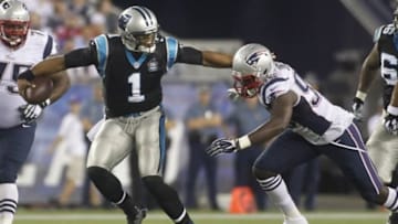Aug 22, 2014; Foxborough, MA, USA; Carolina Panthers quarterback Cam Newton (1) stiff-arms New England Patriots defensive end Chandler Jones (95) during the second quarter at Gillette Stadium. Mandatory Credit: Stew Milne-USA TODAY Sports