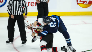 Sep 26, 2021; Winnipeg, Manitoba, CAN; Winnipeg Jets defenseman Logan Stanley (64) fights Ottawa Senators forward Austin Watson (16) during the third period at Canada Life Centre. Mandatory Credit: Terrence Lee-USA TODAY Sports