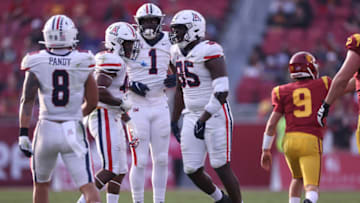 LOS ANGELES, CALIFORNIA - OCTOBER 30: Paris Shand #95 of the Arizona Wildcats celebrates his sack of Kedon Slovis #9 of the USC Trojans with Anthony Pandy #8, Jerry Roberts #48 and Jalen Harris #1 during the first half at Los Angeles Memorial Coliseum on October 30, 2021 in Los Angeles, California. (Photo by Harry How/Getty Images)