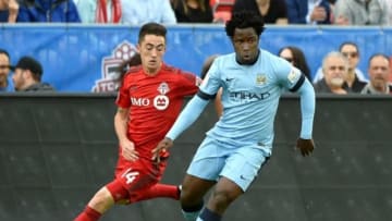 May 27, 2015; Toronto, Ontario, Canada; Manchester City forward Wilfried Bony (14) shields the ball from Toronto FC midfielder Jay Chapman (14) during the first half of an international club friendly at BMO Field. Mandatory Credit: Dan Hamilton-USA TODAY Sports