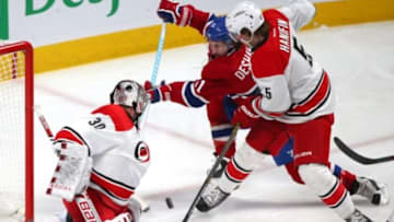 Feb 7, 2016; Montreal, Quebec, CAN; Montreal Canadiens center David Desharnais (51) shoots on Carolina Hurricanes goalie Cam Ward (30) as defenseman Noah Hanifin (5) defends during the first period at Bell Centre. Mandatory Credit: Jean-Yves Ahern-USA TODAY Sports