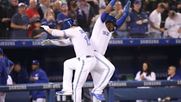 TORONTO, ON - JUNE 05: Randal Grichuk #15 of the Toronto Blue Jays is congratulated by Vladimir Guerrero Jr. #27 after hitting a two-run home run in the first inning during MLB game action against the New York Yankees at Rogers Centre on June 5, 2019 in Toronto, Canada. (Photo by Tom Szczerbowski/Getty Images)