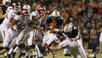 Oct 22, 2016; Auburn, AL, USA; Auburn Tigers running back Kamryn Pittway (36) is tackled by Arkansas Razorbacks linemen Tevin Beanum (97), Jeremiah Ledbetter (55) and linebacker Brooks Ellis (55) during the third quarter at Jordan Hare Stadium. The Tigers beat the Razorbacks 56-3. Mandatory Credit: John Reed-USA TODAY Sports