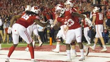 Oct 29, 2016; Madison, WI, USA; Wisconsin Badgers running back Dare Ogunbowale (23) and wide receiver Robert Wheelwright (15) celebrate after scoring a touchdown during overtime against the Nebraska Cornhuskers at Camp Randall Stadium. Wisconsin won 23-17. Mandatory Credit: Jeff Hanisch-USA TODAY Sports