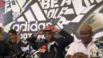 Feb 4, 2015; Long Beach, CA, USA; (editors note: caption correction) Long Beach Poly High Jackrabbits cornerback Iman Marshall (center) announces his decision to attend the University of Southern California flanked by mother Turkessa Lewis (left) and father Carl Lewis at press conference at Long Beach Poly. Mandatory Credit: Kirby Lee-USA TODAY Sports