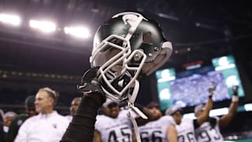 Dec 5, 2015; Indianapolis, IN, USA; A helmet is raised in celebration after the Michigan State Spartans defeated the Iowa Hawkeyes in the Big Ten Conference football championship game at Lucas Oil Stadium. Mandatory Credit: Brian Spurlock-USA TODAY Sports
