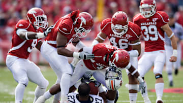 FAYETTEVILLE, AR - OCTOBER 10: Jerico Nelson #31 of the Arkansas Razorbacks gets his helmet stuck to the helmet of Mario Fannin #27 of the Auburn Tigers at the Donald W. Reynolds Stadium on October 10, 2009 in Fayetteville, Arkansas. (Photo by Wesley Hitt/Getty Images)