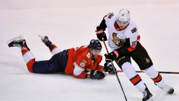 Dec 16, 2019; Sunrise, FL, USA; Ottawa Senators center Logan Brown (21) skates around the defense of Florida Panthers defenseman Aaron Ekblad (5) during the third period at BB&T Center. Mandatory Credit: Jasen Vinlove-USA TODAY Sports