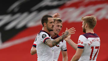 Southampton's English striker Danny Ings (L) celebrates scoring his team's first goal during the English Premier League football match between Bournemouth and Southampton at the Vitality Stadium in Bournemouth, southern England on July 19, 2020. (Photo by Will Oliver / POOL / AFP) / RESTRICTED TO EDITORIAL USE. No use with unauthorized audio, video, data, fixture lists, club/league logos or 'live' services. Online in-match use limited to 120 images. An additional 40 images may be used in extra time. No video emulation. Social media in-match use limited to 120 images. An additional 40 images may be used in extra time. No use in betting publications, games or single club/league/player publications. / (Photo by WILL OLIVER/POOL/AFP via Getty Images)