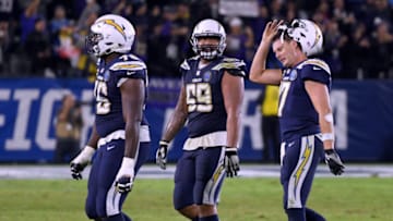 CARSON, CALIFORNIA - DECEMBER 22: Philip Rivers #17, Sam Tevi #69 and Russell Okung #76 of the Los Angeles Chargers walk off the field after a final possession interception during the fourth quarter in a 22-10 Ravens win at StubHub Center on December 22, 2018 in Carson, California. (Photo by Harry How/Getty Images)