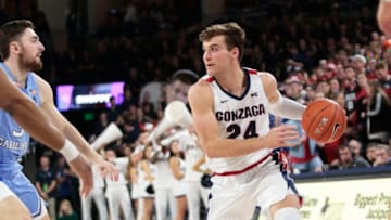 SPOKANE, WASHINGTON - DECEMBER 18: Corey Kispert #24 of the Gonzaga Bulldogs controls the ball against Andrew Patek #3 of the North Carolina Tar Heels in the second half at McCarthey Athletic Center on December 18, 2019 in Spokane, Washington. Gonzaga defeats North Carolina 94-81. (Photo by William Mancebo/Getty Images)