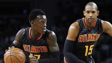 Mar 26, 2016; Auburn Hills, MI, USA; Atlanta Hawks guard Dennis Schroder (17) dribbles the ball past center Al Horford (15) during the fourth quarter against the Detroit Pistons at The Palace of Auburn Hills. Hawks win 112-95. Mandatory Credit: Raj Mehta-USA TODAY Sports