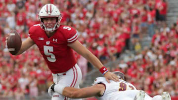 Wisconsin quarterback Graham Mertz eludes a sack by Central Michigan defensive lineman Keegan Cossou in the fourth quarter.Mjs Uwgrid08 12 Hoffman Jpg Uwgrid08