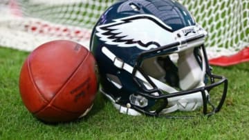 Oct 26, 2014; Glendale, AZ, USA; Detailed view of a Philadelphia Eagles helmet on the field next to a Wilson official NFL football against the Arizona Cardinals at University of Phoenix Stadium. The Cardinals defeated the Eagles 24-20. Mandatory Credit: Mark J. Rebilas-USA TODAY Sports