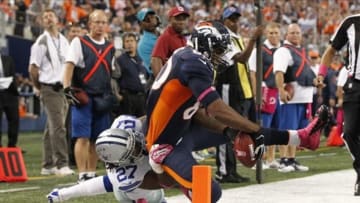 Oct 6, 2013; Arlington, TX, USA; Denver Broncos tight end Julius Thomas (80) reaches for the goal line while being tackled by Dallas Cowboys strong safety J.J. Wilcox (27) in the fourth quarter of the game at AT