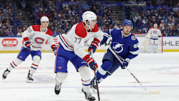 TAMPA, FL - DECEMBER 28: Kirby Dach #77 of the Montreal Canadiens brings the puck into the offensive zone as Mikhail Sergachev #98 of the Tampa Bay Lightning and Juraj Slafkovsky #20 of the Montreal Canadiens follow the play during the first period at the Amalie Arena on December 28, 2022 in Tampa, Florida. (Photo by Mike Carlson/Getty Images)