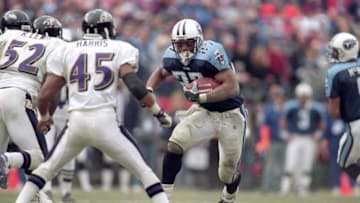 7 Jan 2001: Eddie George #27 of the Tennessee Titans runs with the ball against Corey Harris #45 of the Baltimore Ravens during the AFC Divisional Playoffs Game at the Adelphia Coliseum in Nashville, Tennessee. The Ravens defeated the Titans 24-10. Mandatory Credit: Andy Lyons /Allsport
