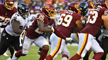 Auburn footballAug 28, 2021; Landover, Maryland, USA; Washington Football Team running back Peyton Barber (25) runs the ball against the Baltimore Ravens during the second quarter at FedExField. Mandatory Credit: Brad Mills-USA TODAY Sports