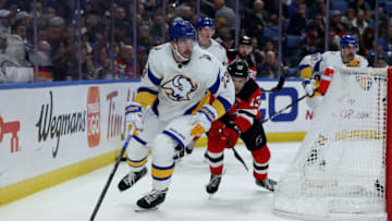 Nov 25, 2022; Buffalo, New York, USA; Buffalo Sabres defenseman Mattias Samuelsson (23) looks to make a pass as New Jersey Devils center Nico Hischier (13) defends during the first period at KeyBank Center. Mandatory Credit: Timothy T. Ludwig-USA TODAY Sports