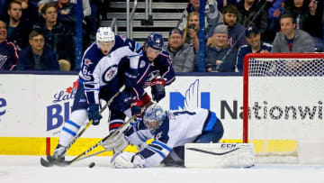 COLUMBUS, OH - APRIL 6: Eric Comrie #1 of the Winnipeg Jets makes a save as Nelson Nogier #62 of the Winnipeg Jets works to keep Josh Anderson #34 of the Columbus Blue Jackets way from the rebound during the game on April 6, 2017 at Nationwide Arena in Columbus, Ohio. Winnipeg defeated Columbus 5-4. (Photo by Kirk Irwin/Getty Images)