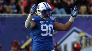 Dec 19, 2015; Las Vegas, NV, USA; Brigham Young Cougars defensive lineman Bronson Kaufusi (90) celebrates in the Las Vegas Bowl against the Utah Utes at Sam Boyd Stadium. Utah defeated BYU 35-28. Mandatory Credit: Kirby Lee-USA TODAY Sports