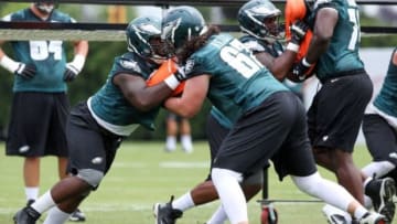 Jul 26, 2014; Philadelphia, PA, USA; Philadelphia Eagles tackle Dennis Kelly (67) and guard Donald Hawkins (78) battle during training camp drills at the Novacare Complex. Mandatory Credit: Bill Streicher-USA TODAY Sports
