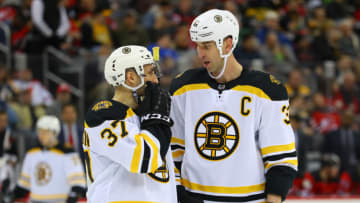 NEWARK, NJ - MARCH 21: Boston Bruins defenseman Zdeno Chara (3) talks with Boston Bruins center Patrice Bergeron (37) during the National Hockey League game between the New Jersey Devils and the Boston Bruins on March 21, 2019 at the Prudential Center in Newark, NJ. (Photo by Rich Graessle/Icon Sportswire via Getty Images)