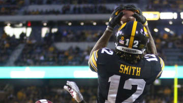 IOWA CITY, IOWA- AUGUST 31: Wide receiver Brandon Smith #12 of the Iowa Hawkeyes makes a touchdown reception in the first half in front of defensive back Emmanuel Rugamba #5 of the Miami Ohio RedHawks on August 31, 2019 at Kinnick Stadium in Iowa City, Iowa. (Photo by Matthew Holst/Getty Images)