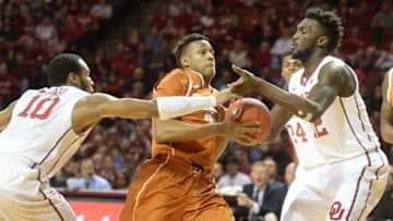 Feb 8, 2016; Norman, OK, USA; Texas Longhorns guard Demarcus Holland (2) prepares to shoot the ball between Oklahoma Sooners guard Jordan Woodard (10) and forward Khadeem Lattin (12) during the first half at Lloyd Noble Center. Mandatory Credit: Mark D. Smith-USA TODAY Sports