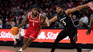 Houston Cougars guard Jamal Shead drives on Cincinnati Bearcats guard David DeJulius at Fifth Third Arena. The Enquirer.