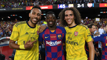 BARCELONA, SPAIN - AUGUST 04: Pierre-Emerick Aubameyang and Matteo Guendouzi of Arsenal with Ousmane Dembele of Barcelona after the match between FC Barcelona and Arsenal at Nou Camp on August 04, 2019 in Barcelona, Spain. (Photo by David Price/Arsenal FC via Getty Images)