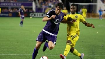 Aug 1, 2015; Orlando, FL, USA; Orlando City SC midfielder Kaka (10) and Columbus Crew defender Waylon Francis (14) fight to control the ball during the second half at Orlando Citrus Bowl Stadium. Orlando City SC defeated the Columbus Crew 5-2. Mandatory Credit: Kim Klement-USA TODAY Sports