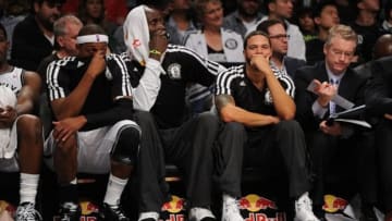 Oct 12, 2013; Brooklyn, NY, USA; From left Brooklyn Nets small forward Paul Pierce and Brooklyn Nets power forward Kevin Garnett and Brooklyn Nets point guard Deron Williams look on against the Detroit Pistons during the second half of the preseason game at Barclays Center. The Pistons won the game 99-88 Mandatory Credit: Joe Camporeale-USA TODAY Sports