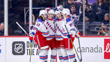 WINNIPEG, MB - FEBRUARY 11: Mika Zibanejad #93, Chris Kreider #20, Jacob Trouba #8 and Pavel Buchnevich #89 of the New York Rangers celebrate a first period goal against the Winnipeg Jets at the Bell MTS Place on February 11, 2020 in Winnipeg, Manitoba, Canada. (Photo by Darcy Finley/NHLI via Getty Images)