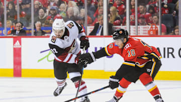 CALGARY, AB - FEBRUARY 18: Derek Ryan #10 of the Calgary Flames checks Conor Garland #83 of the Arizona Coyotes during an NHL game at Scotiabank Saddledome on February 18, 2019 in Calgary, Alberta, Canada. (Photo by Derek Leung/Getty Images)