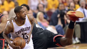 May 25, 2016; Cleveland, OH, USA; Cleveland Cavaliers center Tristan Thompson (13) grabs a rebound ahead of Toronto Raptors center Bismack Biyombo (8) during the second half in game five of the Eastern conference finals of the NBA Playoffs at Quicken Loans Arena. The Cavs won 116-78. Mandatory Credit: Ken Blaze-USA TODAY Sports